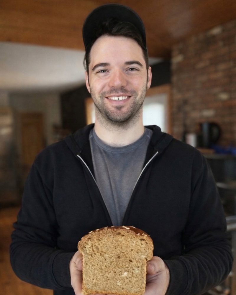 Jeff Raymond, owner of Metta Personal Chef, holding a loaf of fresh bread.